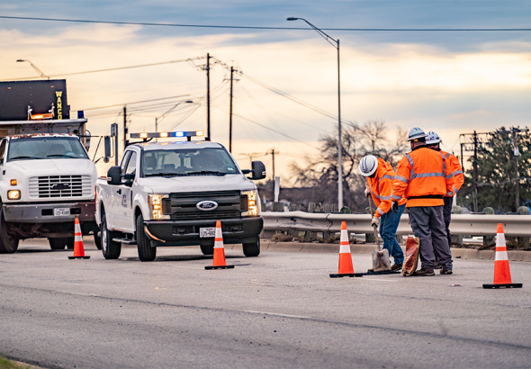maintenance-workers-vehicles-fill-potholes