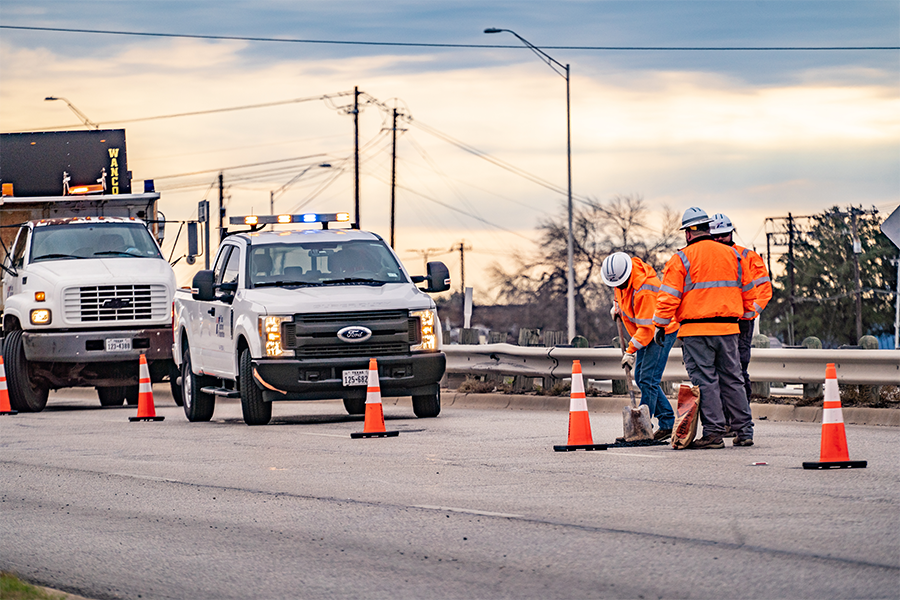 maintenance-workers-vehicles-fill-potholes